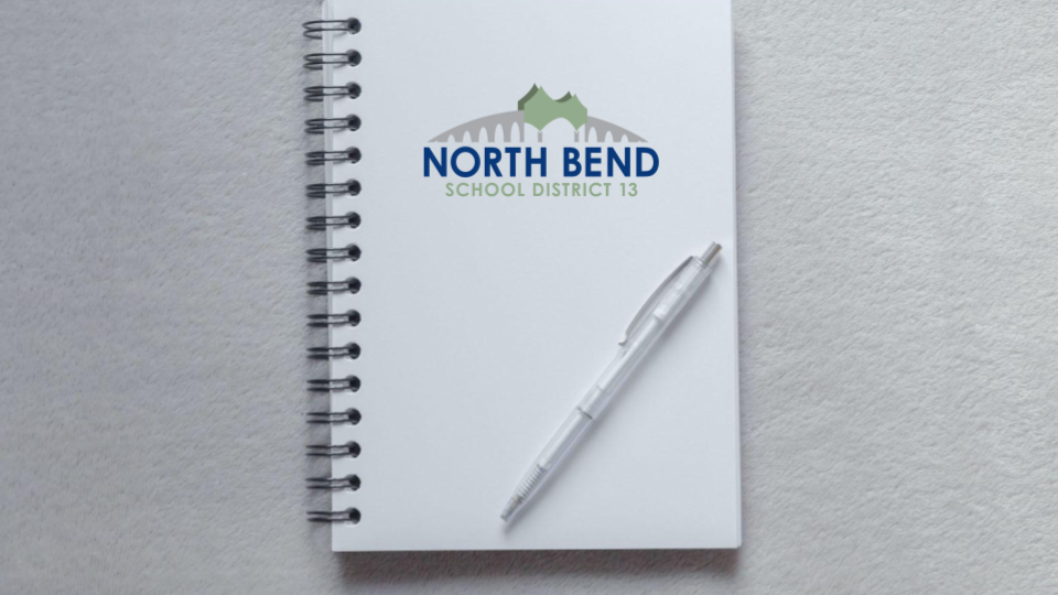 A Notebook and Pen with the NBSD Logo