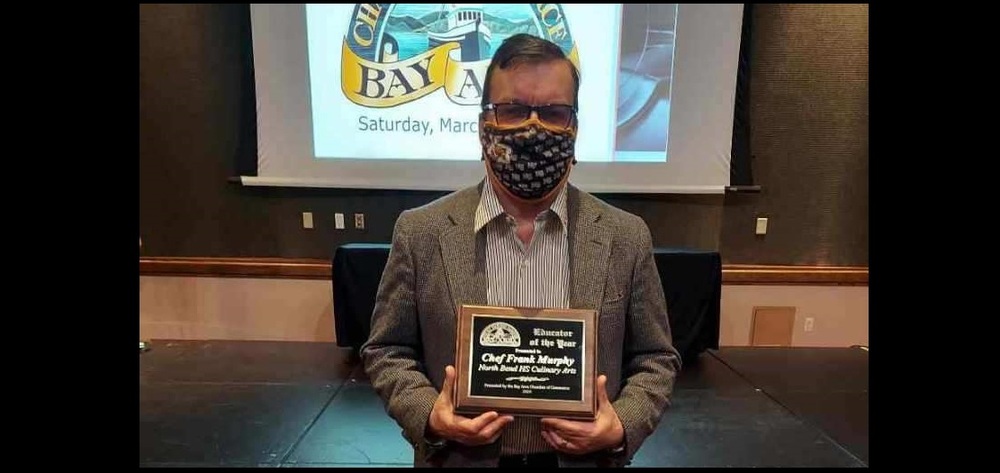 Chef Murphy holding the 2020 BACC Educator of the Year Award