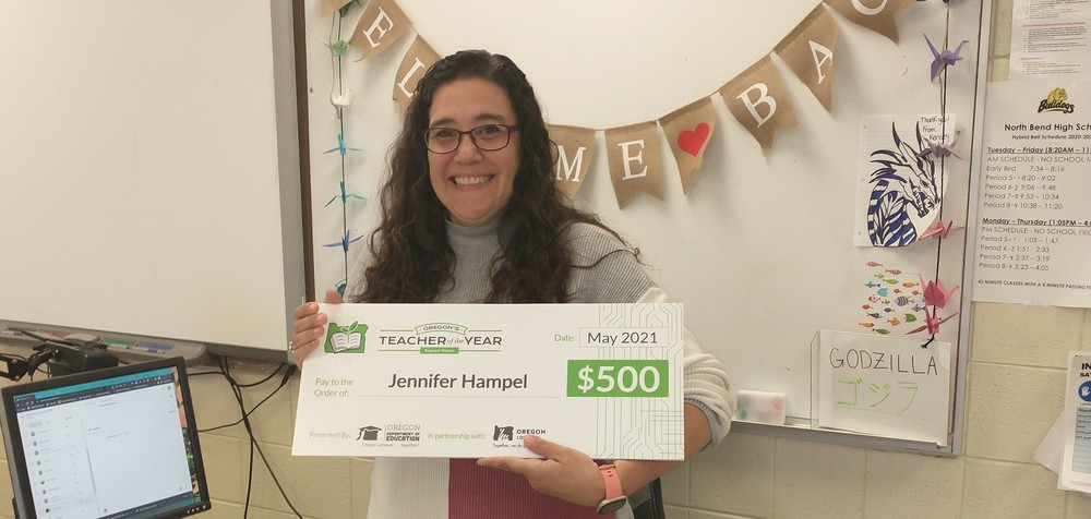 Jennifer Hampel holding the 2021 Regional Teacher of the Year Award