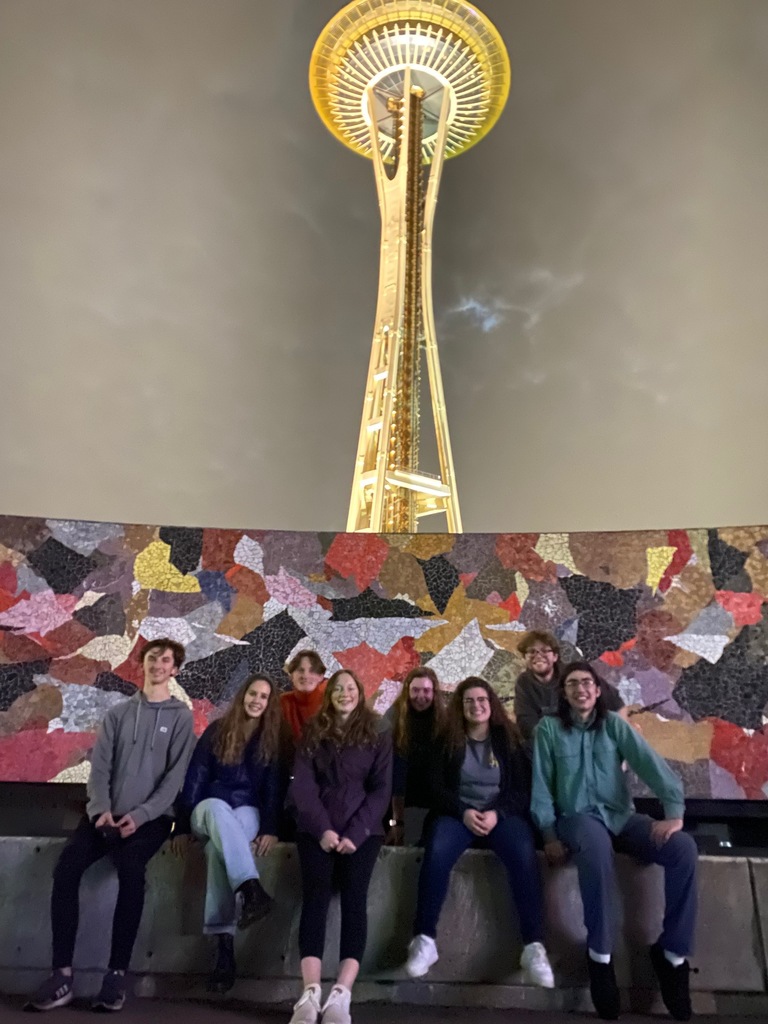 Students sitting in front of the Seattle Space Needle