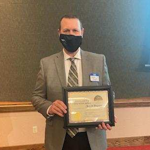Superintendent Kevin Bogatin holding his certificate